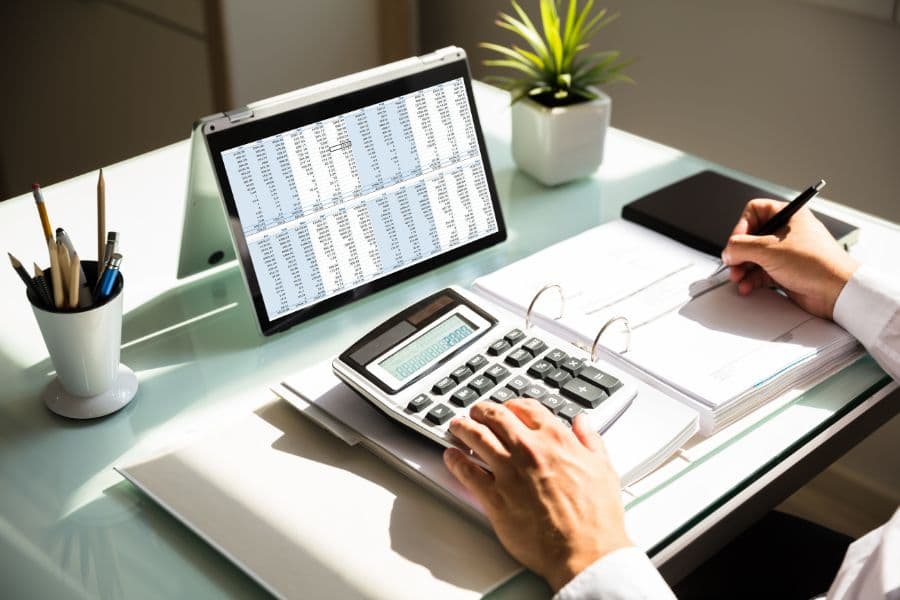 business manager calculating total cost of ownership (TCO) of packaging operation