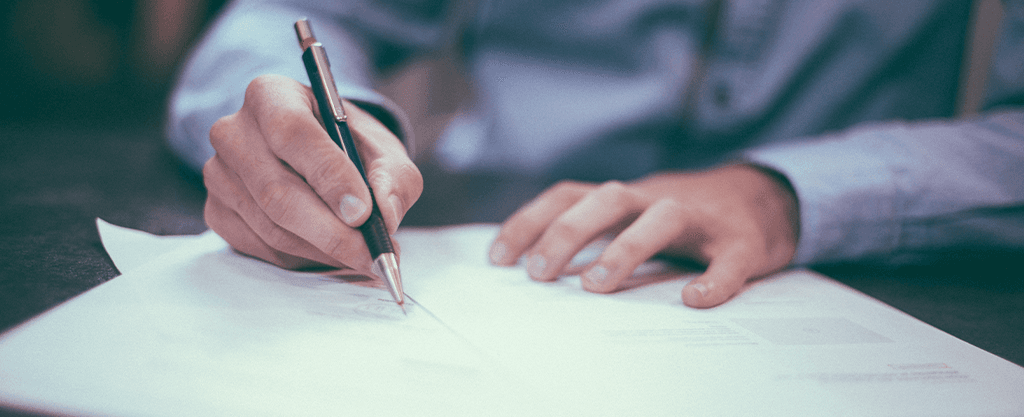 Image of person filling out paper forms